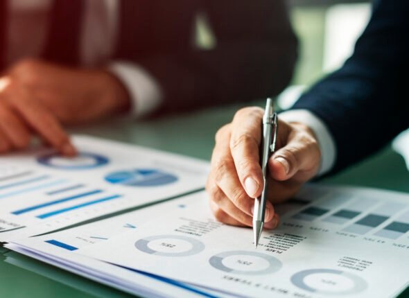 Hands Writing Business Documents Desk Concept