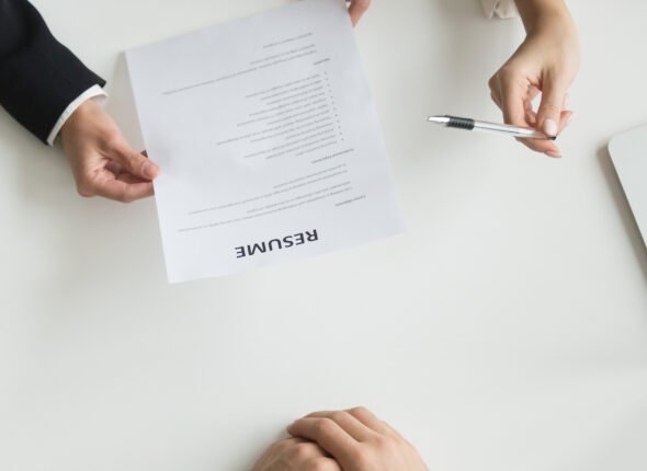 Hr reading applicants resume at job interview, top closeup view